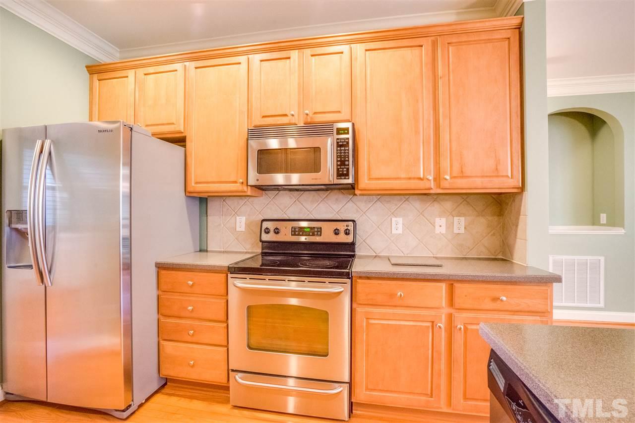 2303 Dunlin Lane Raleigh, NC 27614 - Photo 8 of 25 a kitchen with granite countertop cabinets stainless steel appliances and a window