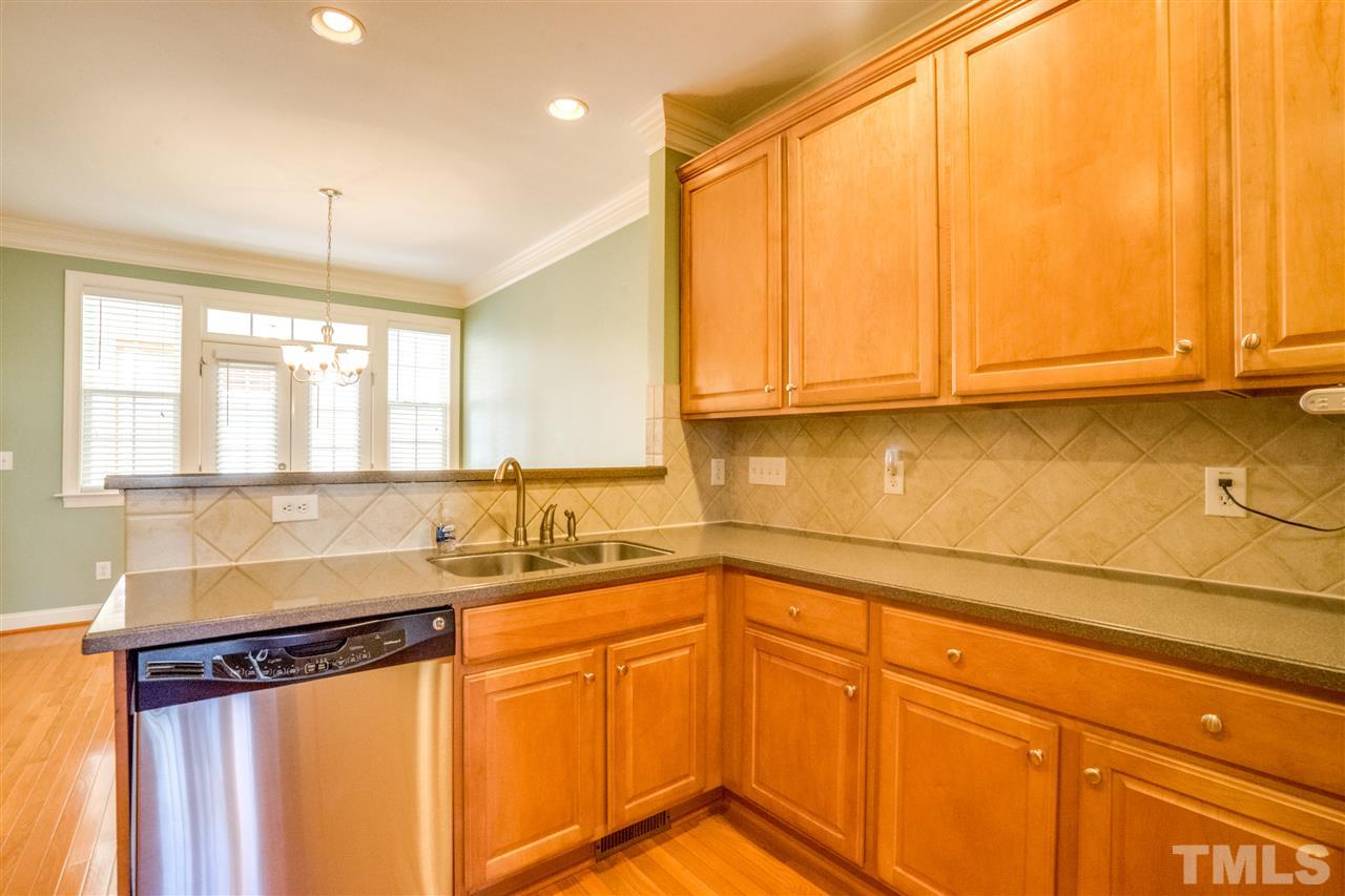 2303 Dunlin Lane Raleigh, NC 27614 - Photo 9 of 25 a kitchen with stainless steel appliances granite countertop a sink a stove and a microwave