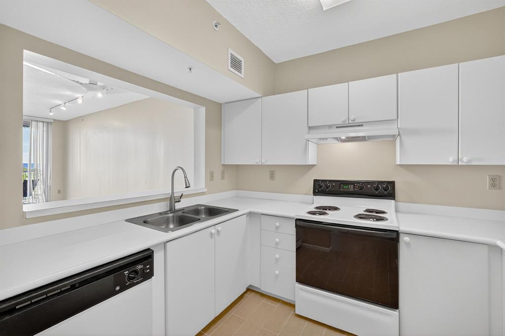 3020 Northeast 32nd Avenue, Unit 819 Fort Lauderdale, FL 33308 - Photo 12 of 68 a kitchen with appliances a sink and cabinets