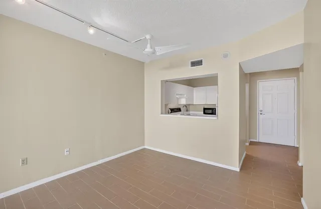 an empty room with sliding door and wooden floor