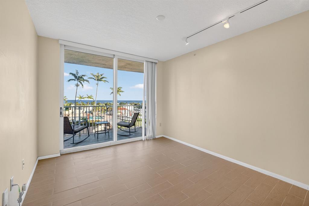 3020 Northeast 32nd Avenue, Unit 819 Fort Lauderdale, FL 33308 - Photo 16 of 68 an empty room with sliding door and wooden floor