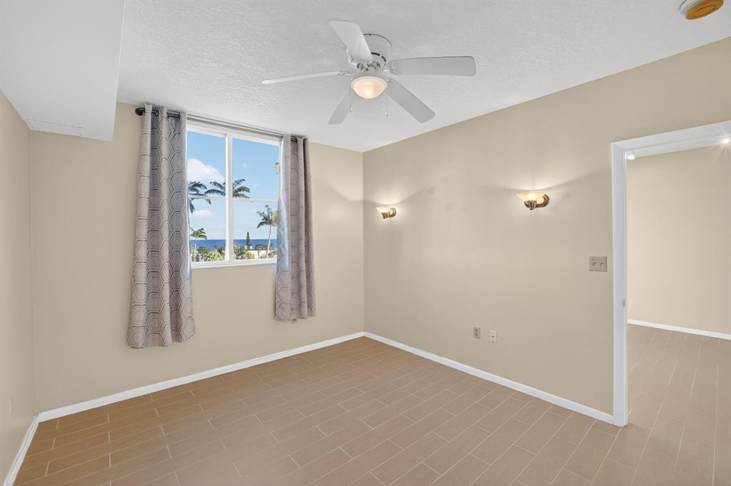3020 Northeast 32nd Avenue, Unit 819 Fort Lauderdale, FL 33308 - Photo 20 of 68 an empty room with windows and fan