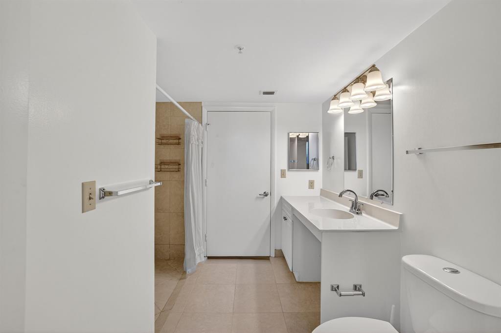 3020 Northeast 32nd Avenue, Unit 819 Fort Lauderdale, FL 33308 - Photo 23 of 68 a bathroom with a sink toilet and mirror