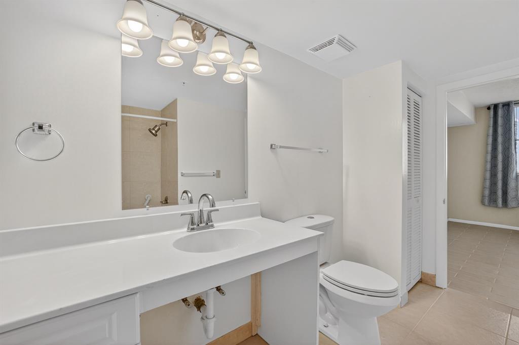 3020 Northeast 32nd Avenue, Unit 819 Fort Lauderdale, FL 33308 - Photo 24 of 68 a bathroom with a sink a toilet and shower