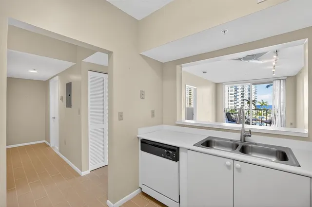 a kitchen with a stove a refrigerator and white cabinets