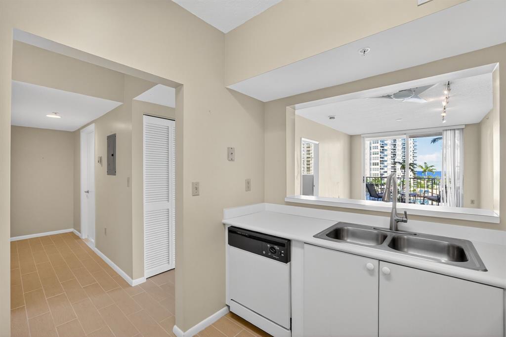 3020 Northeast 32nd Avenue, Unit 819 Fort Lauderdale, FL 33308 - Photo 9 of 68 a kitchen with a sink and cabinets