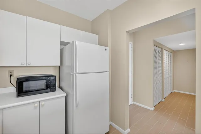 a kitchen with appliances a sink and cabinets
