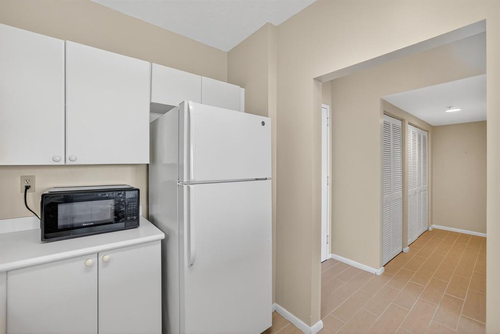 3020 Northeast 32nd Avenue, Unit 819 Fort Lauderdale, FL 33308 - Photo 10 of 68 a kitchen with a refrigerator sink and microwave