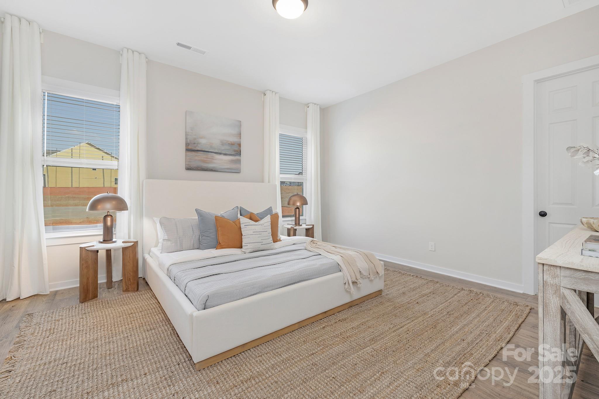 13097 Arnold Palmer Circle, Unit 844 Lancaster, SC 29720 - Photo 15 of 38 a bedroom with a bed and a table