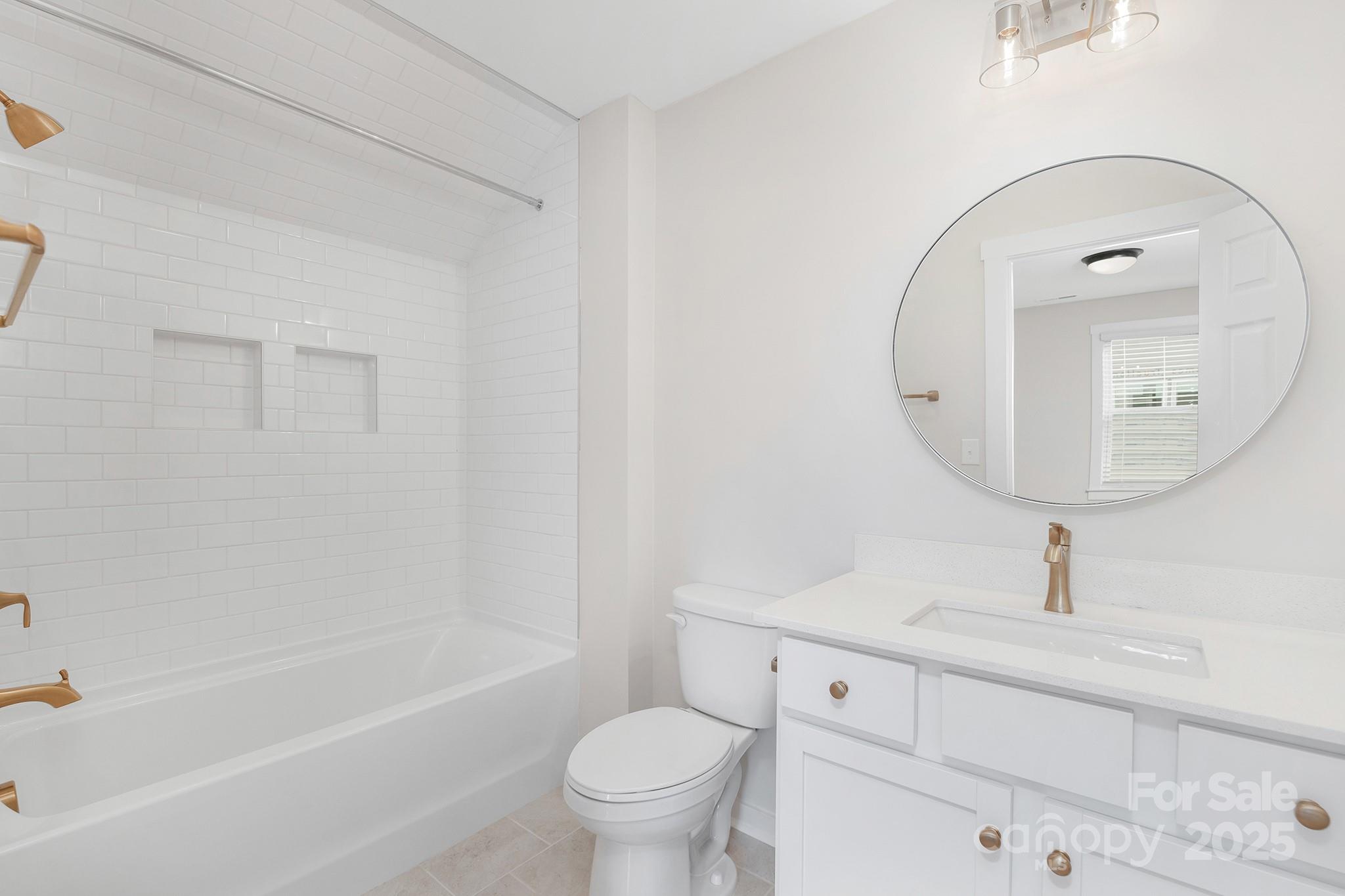 13097 Arnold Palmer Circle, Unit 844 Lancaster, SC 29720 - Photo 23 of 38 a bathroom with a sink a toilet and a mirror