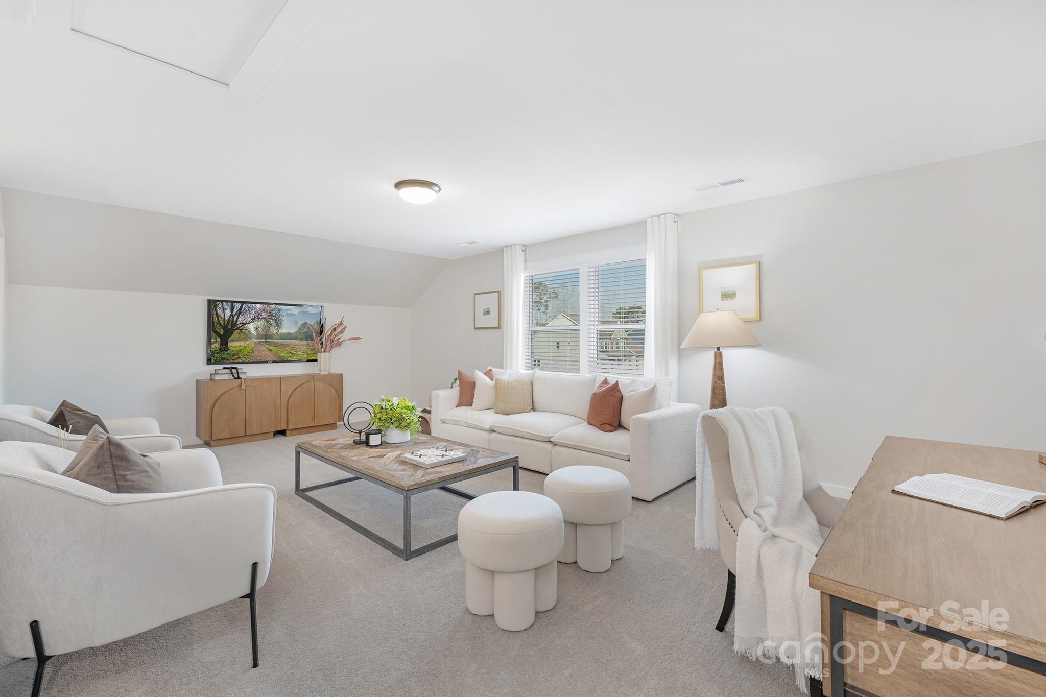 13097 Arnold Palmer Circle, Unit 844 Lancaster, SC 29720 - Photo 25 of 38 a living room with furniture and a large window