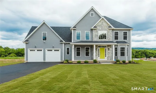 a front view of house with yard and green space