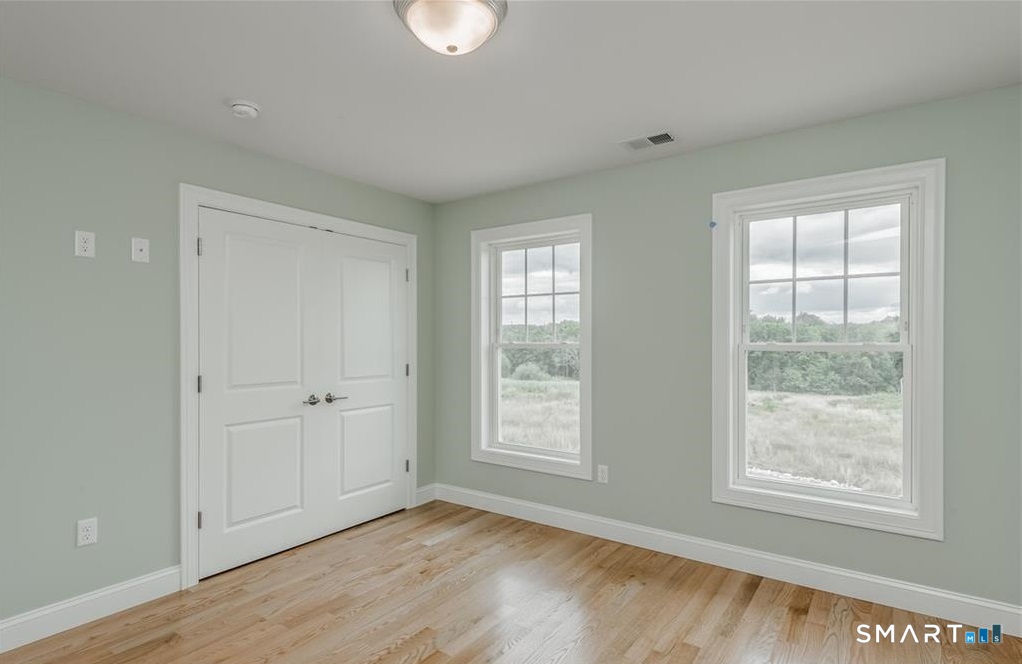 106 Rock Ridge Road Manchester, CT 06040 - Photo 15 of 19 a view of an empty room with wooden floor and a window