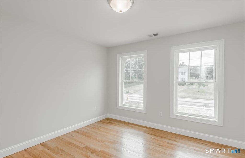 106 Rock Ridge Road Manchester, CT 06040 - Photo 17 of 19 a view of an empty room with wooden floor and a window