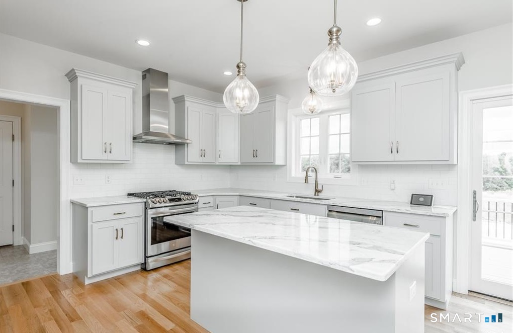106 Rock Ridge Road Manchester, CT 06040 - Photo 2 of 19 a kitchen with cabinets stainless steel appliances and wooden floor