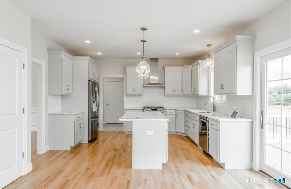 106 Rock Ridge Road Manchester, CT 06040 - Photo 3 of 19 a large kitchen with cabinets wooden floor and stainless steel appliances