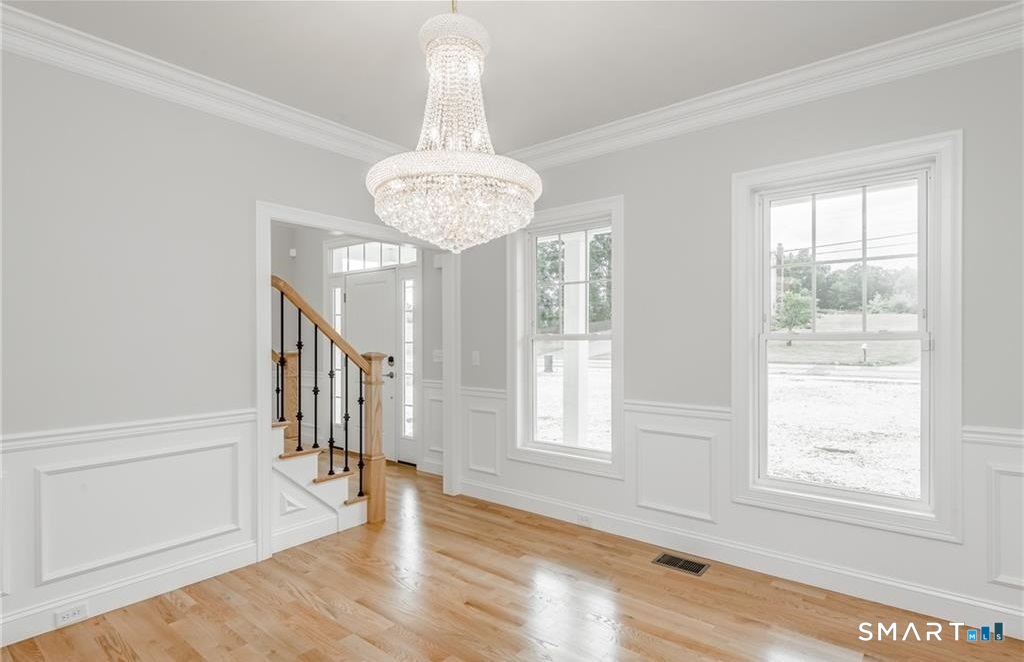 106 Rock Ridge Road Manchester, CT 06040 - Photo 6 of 19 a view of an empty room with wooden floor and a window