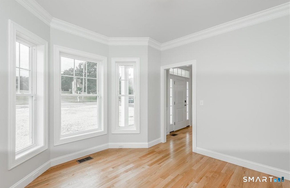 106 Rock Ridge Road Manchester, CT 06040 - Photo 8 of 19 an empty room with wooden floor and windows