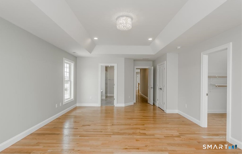106 Rock Ridge Road Manchester, CT 06040 - Photo 9 of 19 a view of an empty room with wooden floor and a window