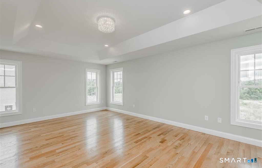 106 Rock Ridge Road Manchester, CT 06040 - Photo 10 of 19 an empty room with wooden floor and windows