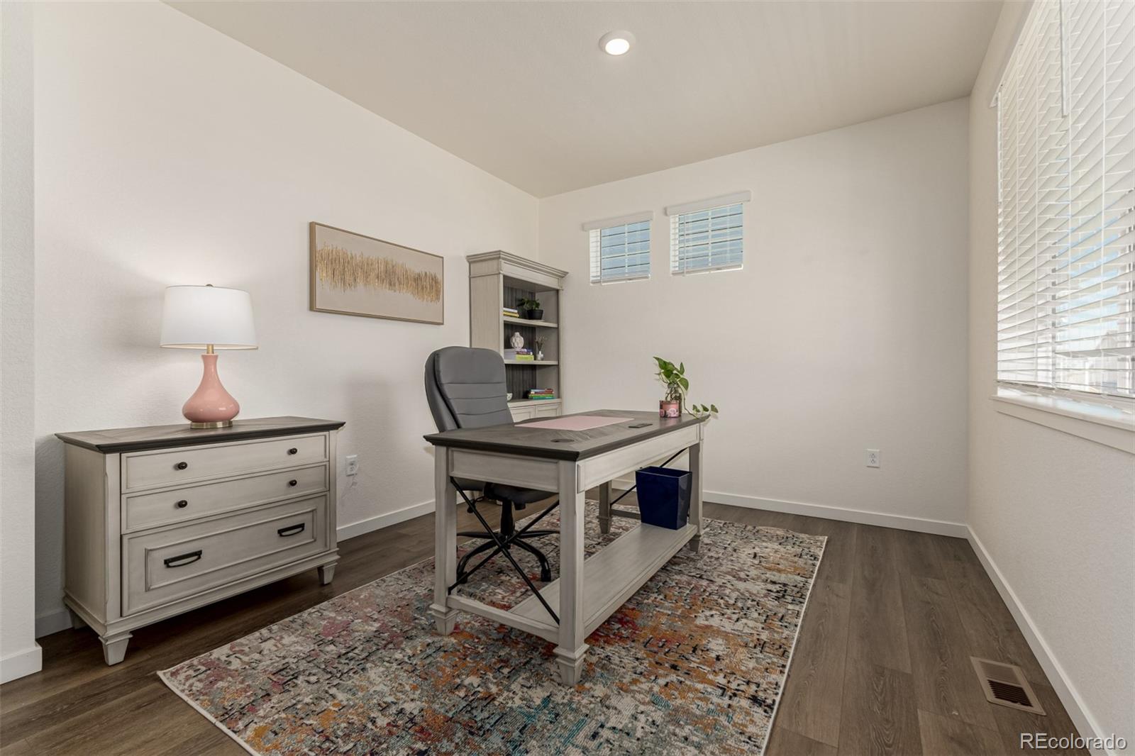 773 Allium Street Watkins, CO 80137 - Photo 11 of 46 a room with furniture and wooden floor