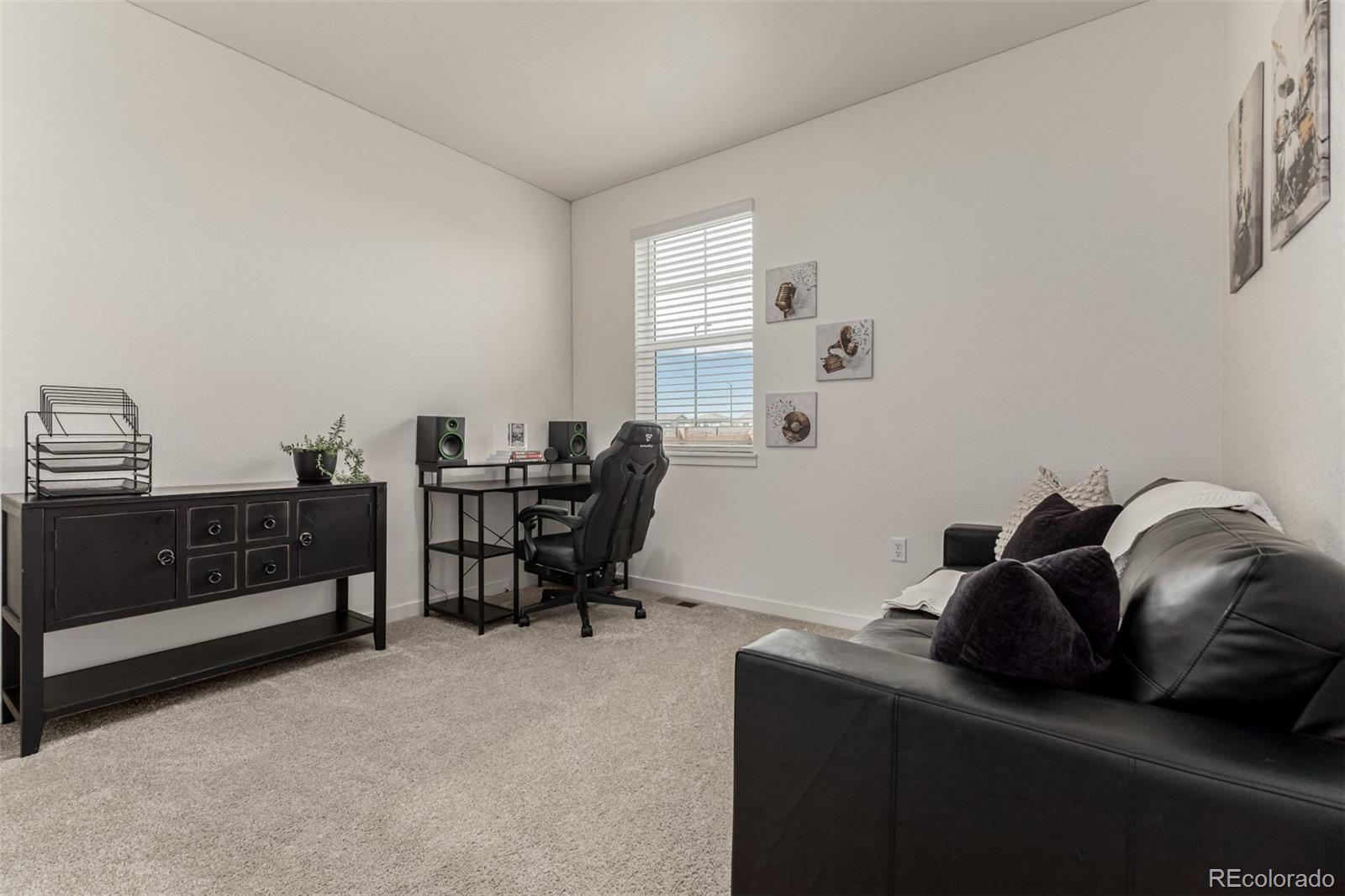 773 Allium Street Watkins, CO 80137 - Photo 12 of 46 a room with a couch and a piano