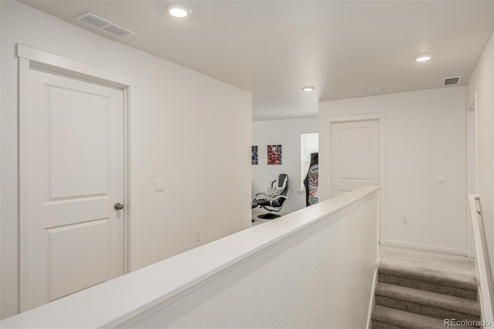 773 Allium Street Watkins, CO 80137 - Photo 15 of 46 a view of a hallway with wooden floor and a living room
