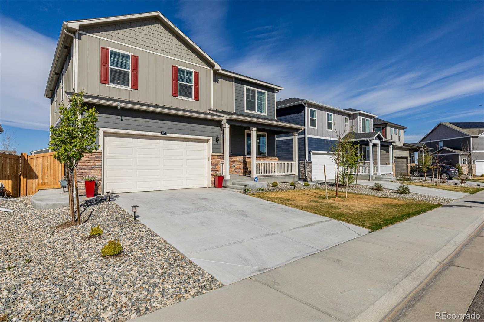 773 Allium Street Watkins, CO 80137 - Photo 2 of 46 a front view of a house with a yard
