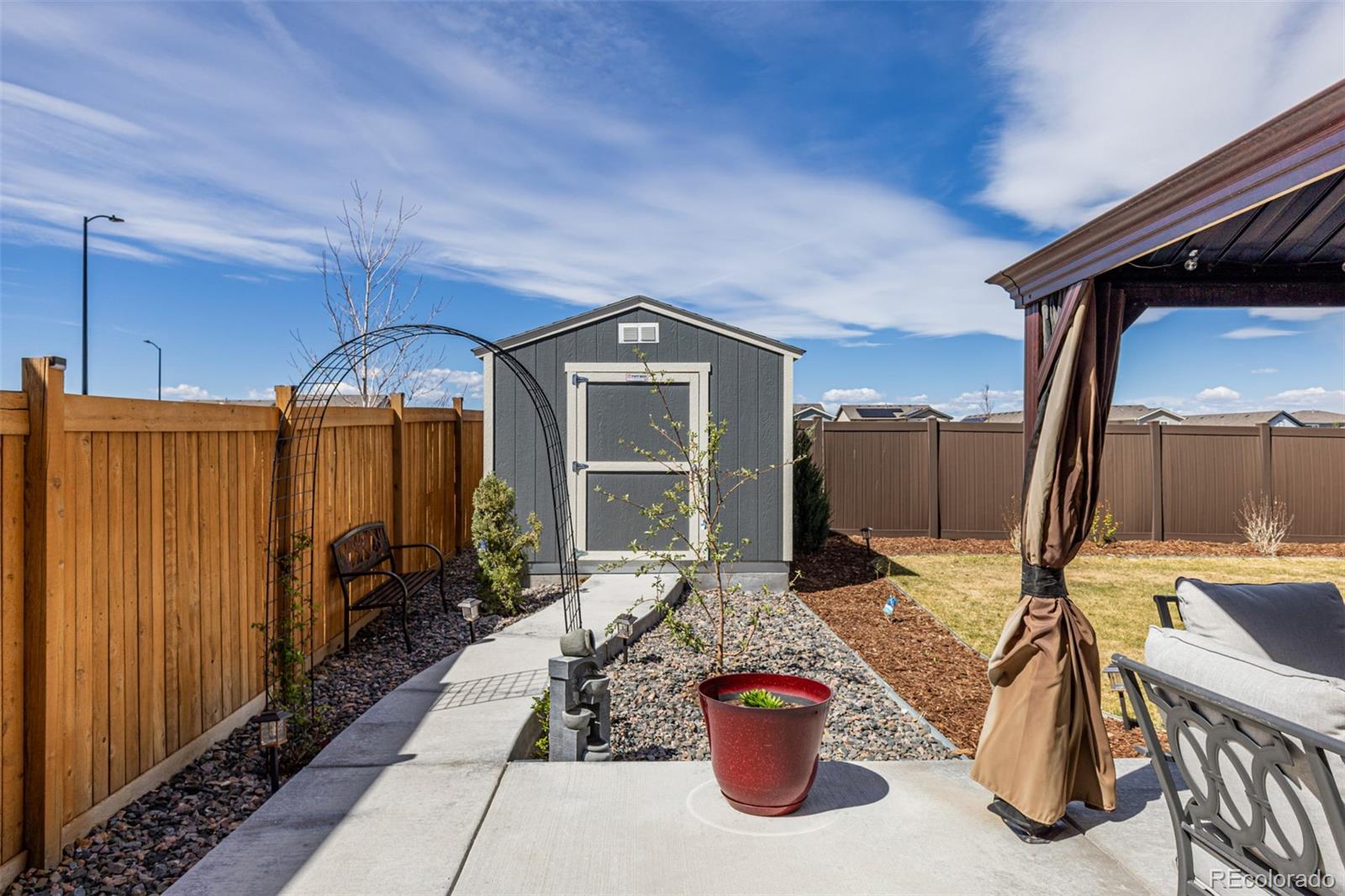 773 Allium Street Watkins, CO 80137 - Photo 32 of 46 a front view of a house with a chairs