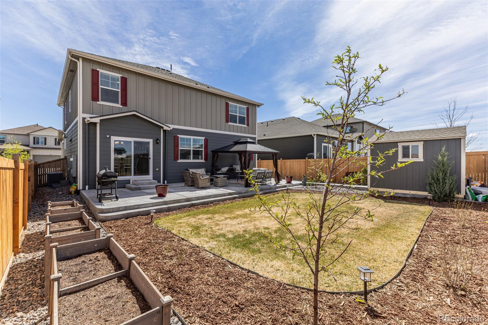 773 Allium Street Watkins, CO 80137 - Photo 35 of 46 a view of a house with swimming pool and sitting area