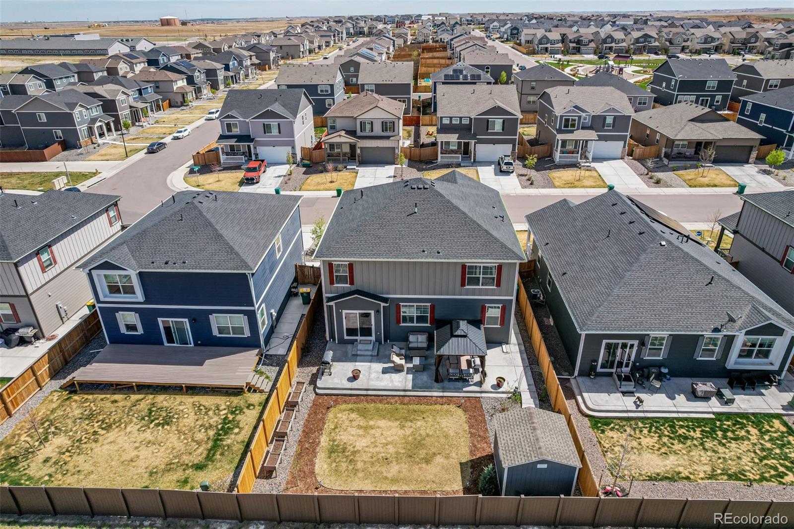 773 Allium Street Watkins, CO 80137 - Photo 39 of 46 an aerial view of a house with swimming pool and ocean view
