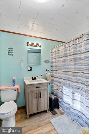 a bathroom with a sink toilet and a mirror