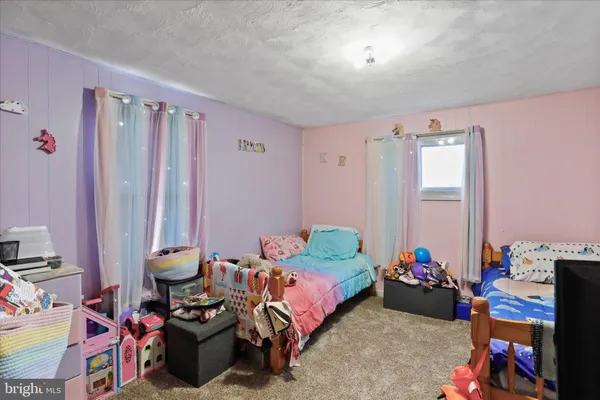 a bedroom with bed and a window