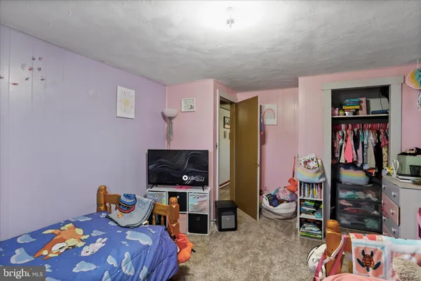 a bedroom with a bed and a chair