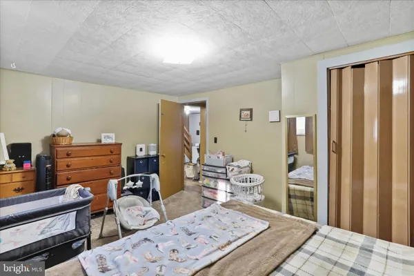 a view of hallway with furniture and a refrigerator