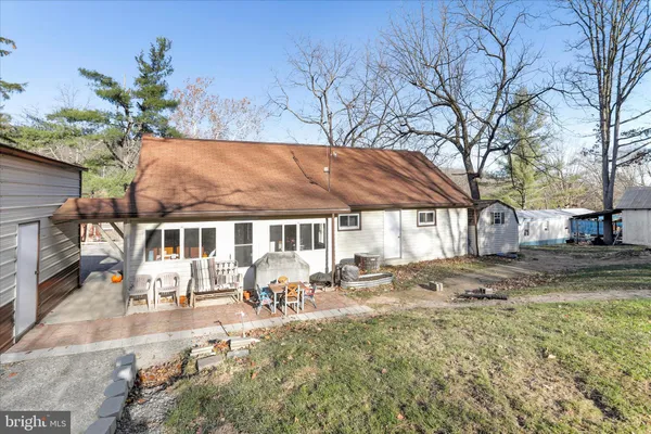 a view of a house with garden and sitting area