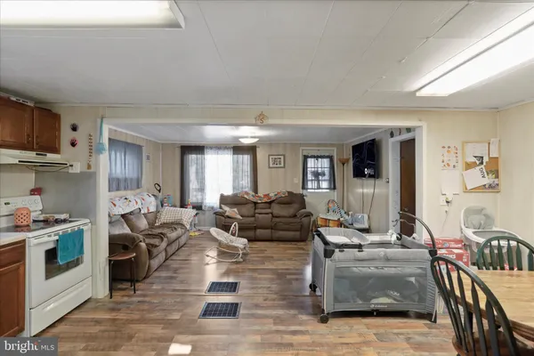 a living room with furniture wooden floor and a fireplace