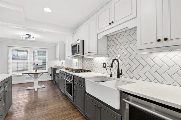 a kitchen with a sink stove and cabinets