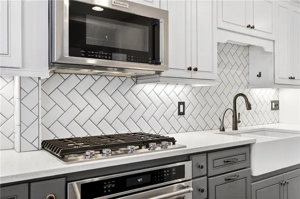 a kitchen with granite countertop a stove and a sink