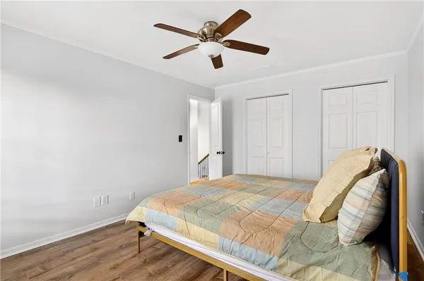 a bedroom with a large bed and a potted plant
