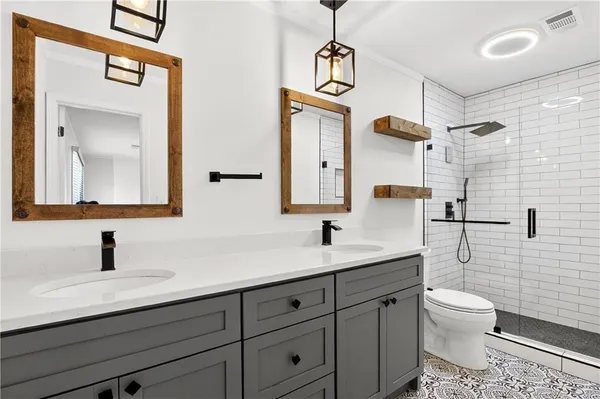 a bathroom with a toilet and a shower
