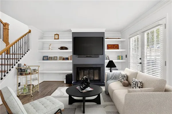a living room with furniture a fireplace and a flat screen tv