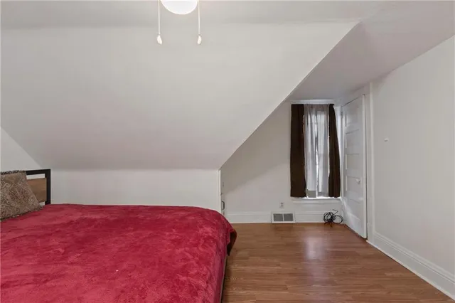 a view of a room with wooden floor and staircase
