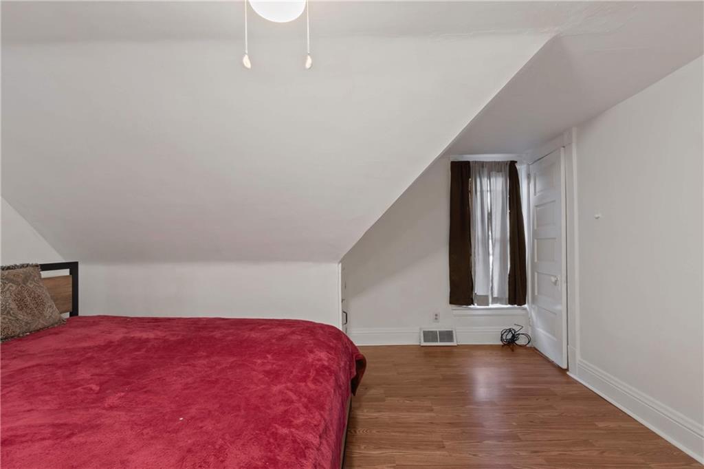 999 Thompson Avenue Donora, PA 15033 - Photo 18 of 24 a view of a room with wooden floor and staircase