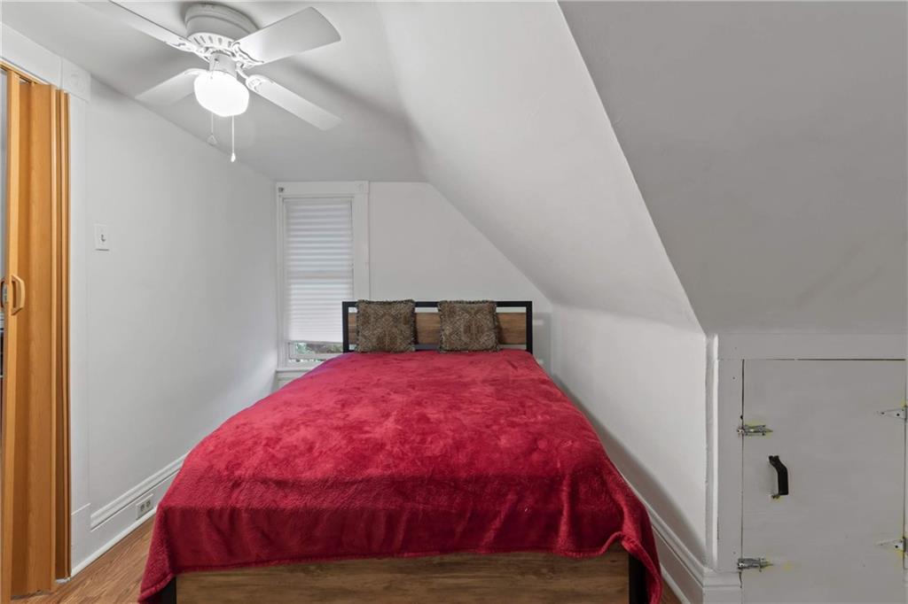 999 Thompson Avenue Donora, PA 15033 - Photo 19 of 24 a bedroom with a bed and a chandelier