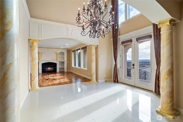 a view of an empty room with a fireplace and a window