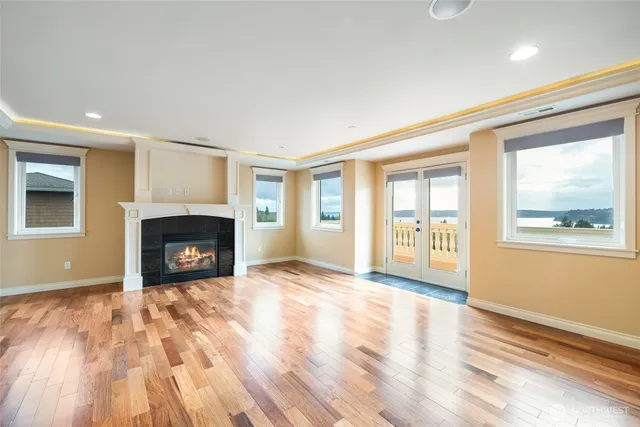 a view of an empty room with a fireplace and a window