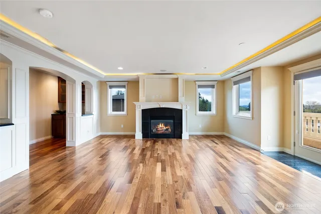 a view of an empty room with window and fire place