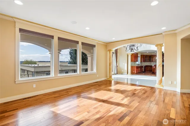 a kitchen with stainless steel appliances granite countertop a sink a stove and a wooden floors
