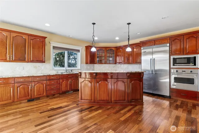 a kitchen with stainless steel appliances granite countertop a stove and a sink